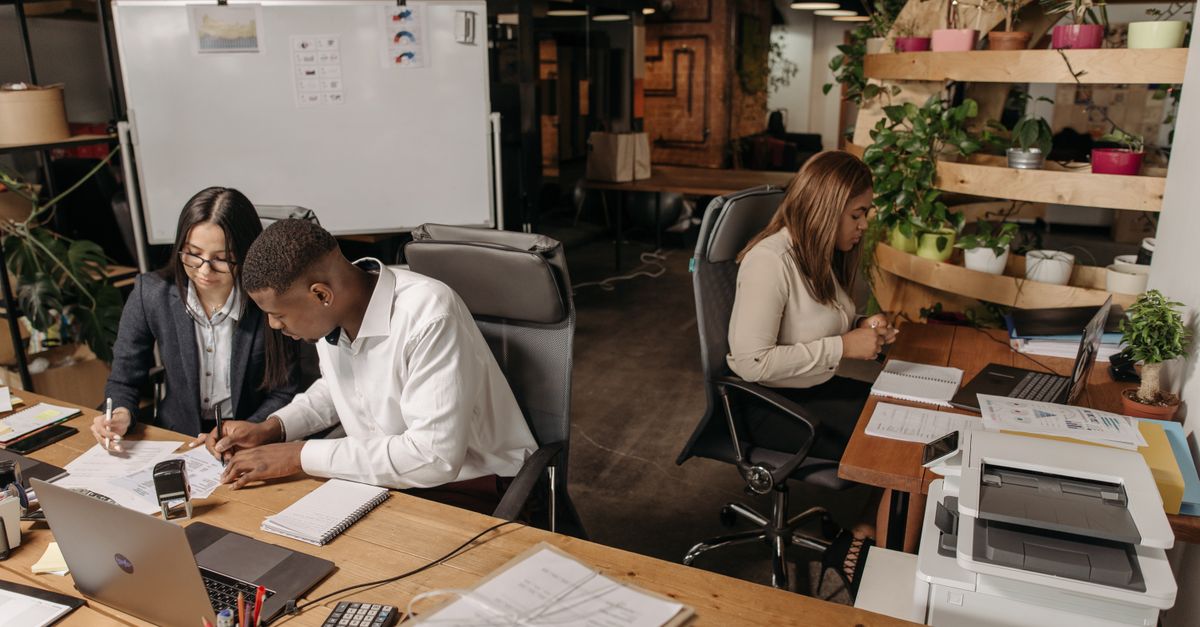 Teamwork in a modern office with diverse colleagues working together on documents.